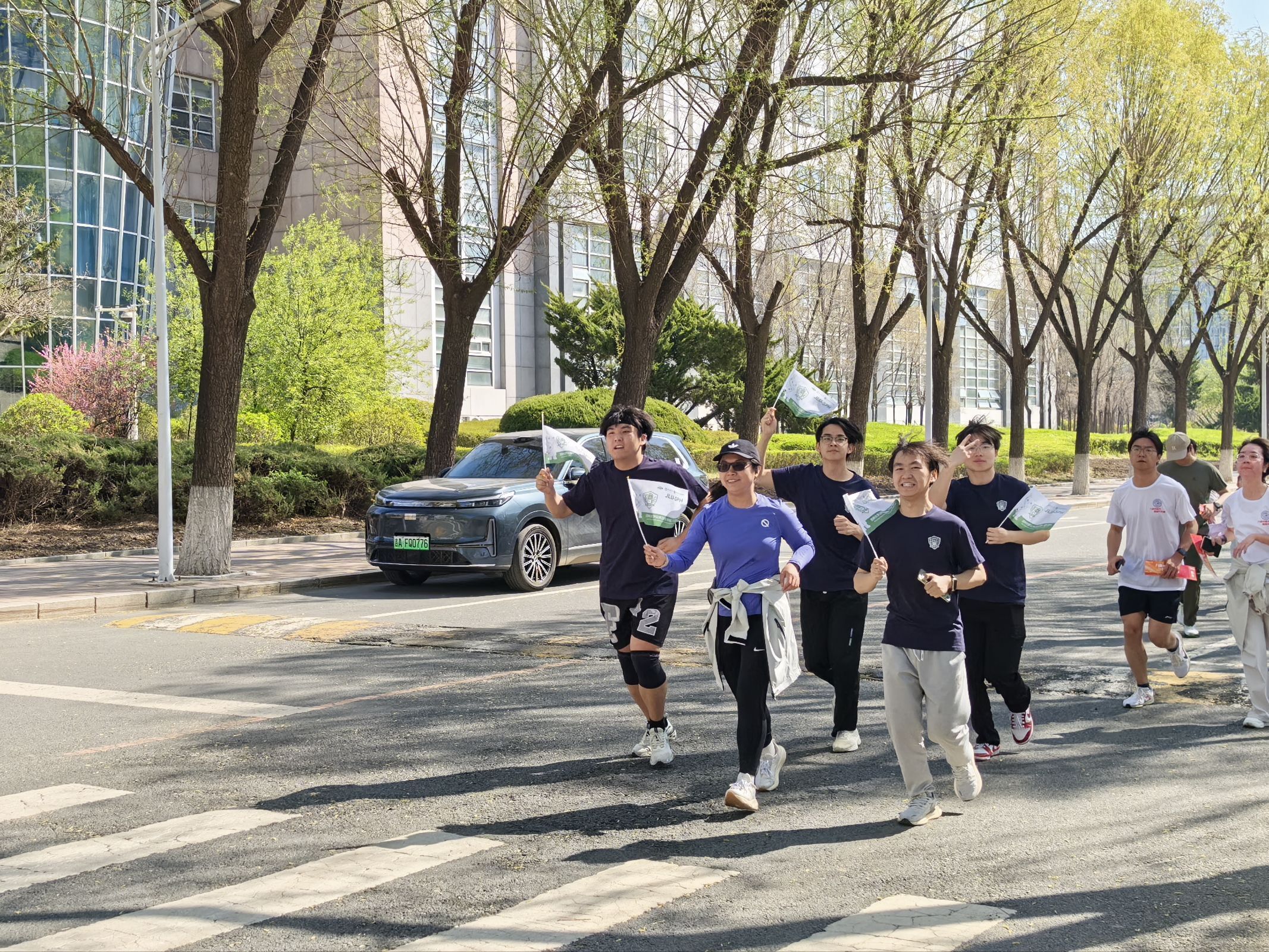 Participants running together along a campus path