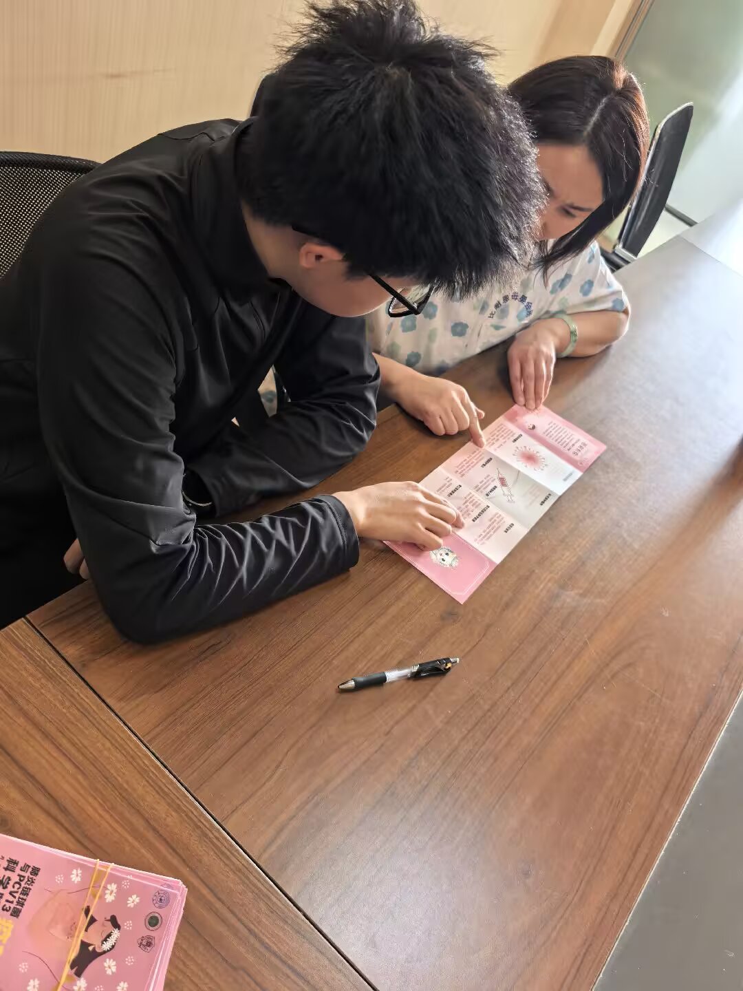 A participant reading an illustrated information card