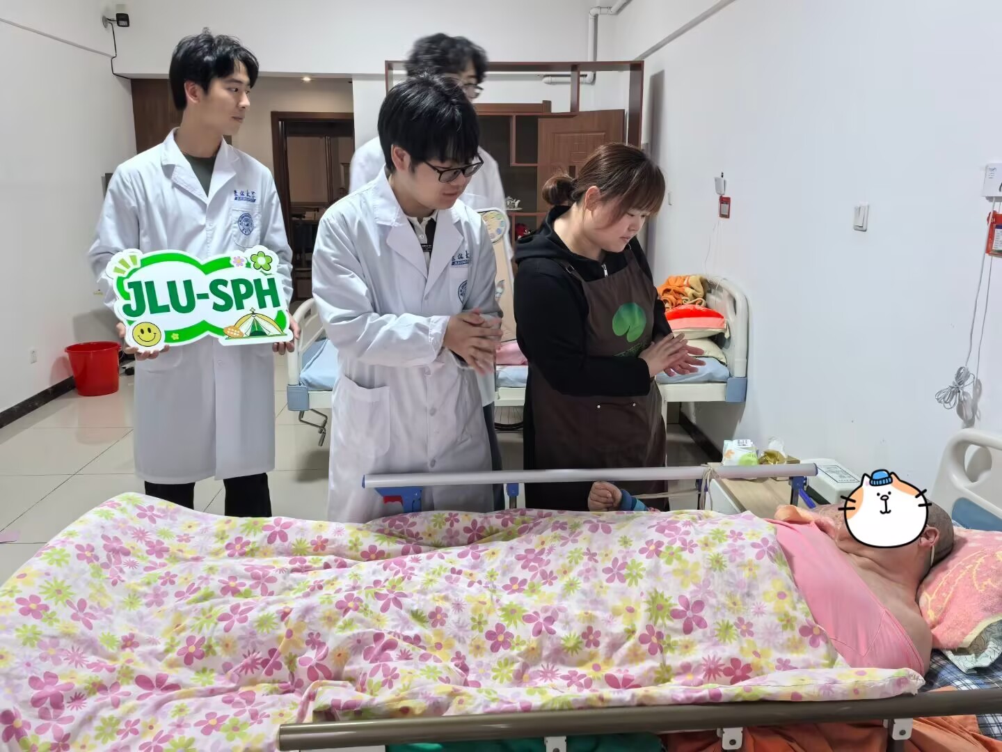 Team members using a leaflet in a bedside conversation with a caregiver