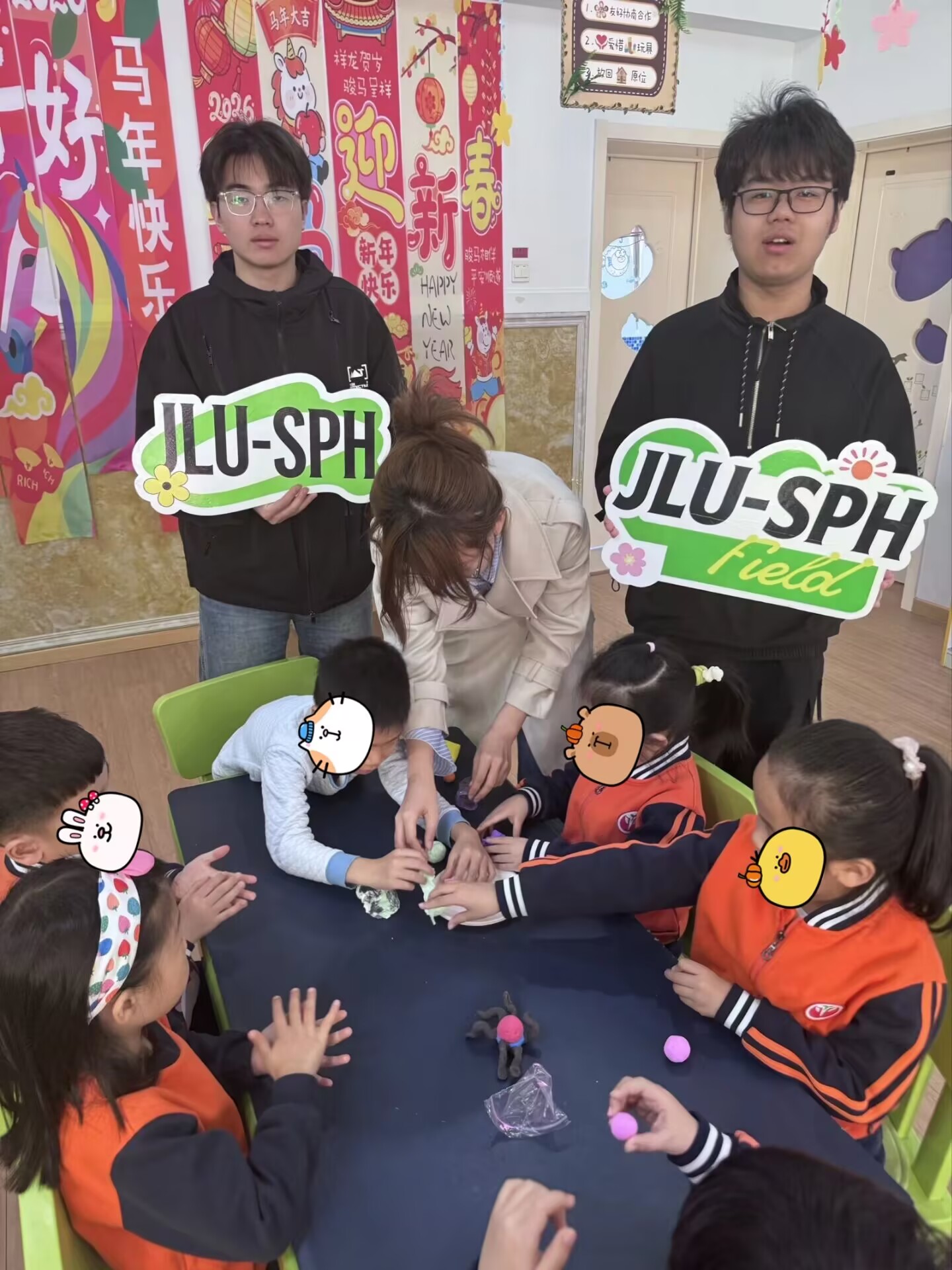 Volunteers guiding children as they build clay models