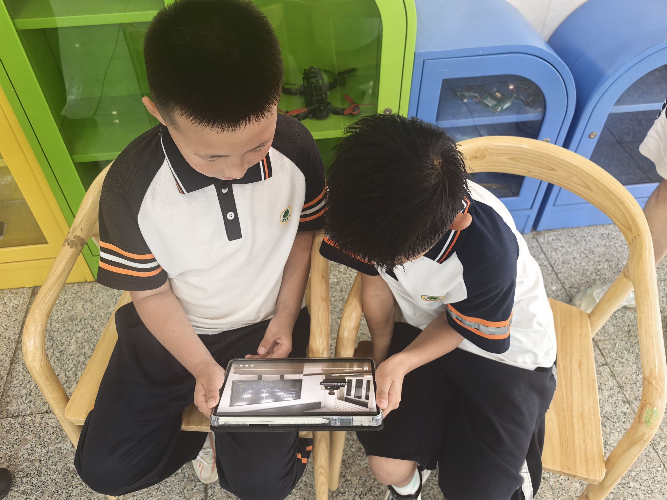Two children viewing the online learning material on a tablet