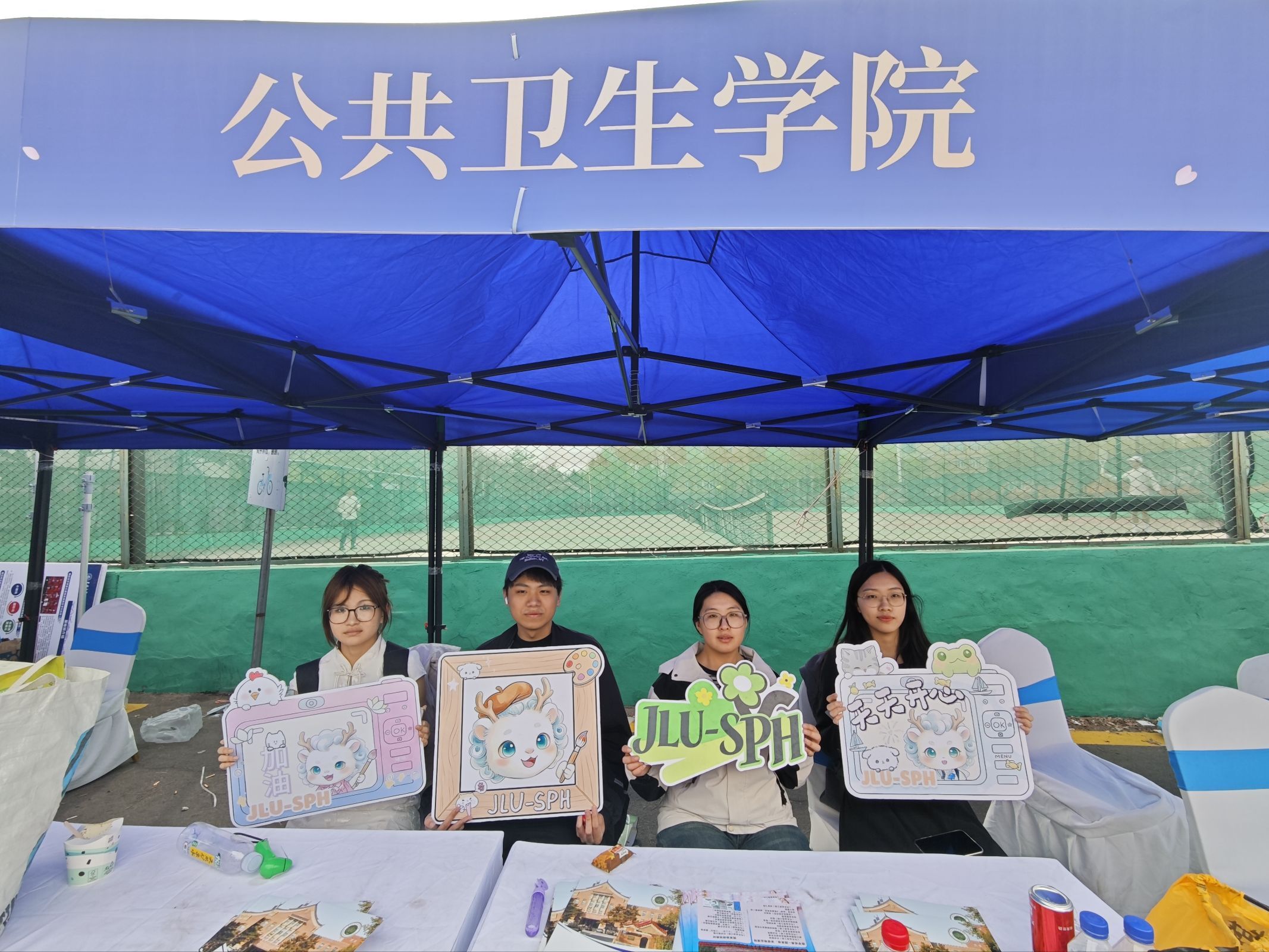 Volunteers showing illustrated materials at the public-health booth