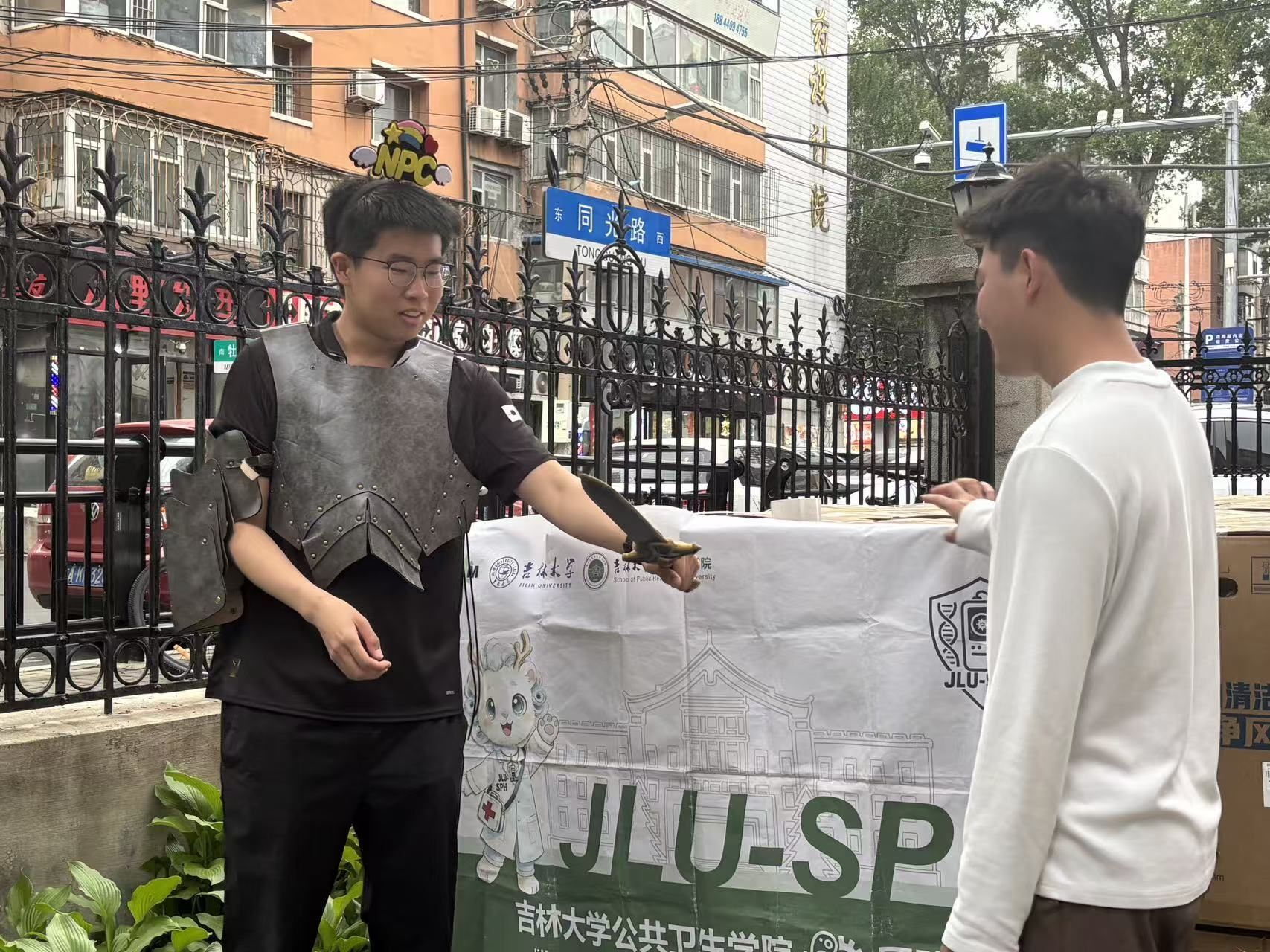 A team member speaking with a student outside the residence hall