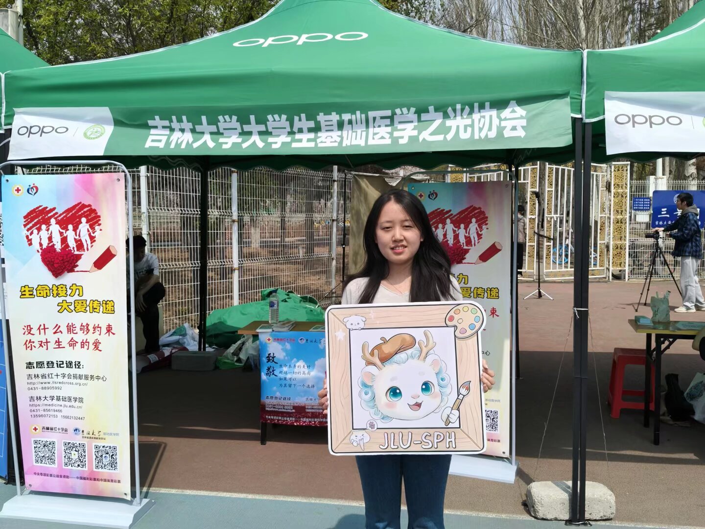 A volunteer displaying an illustrated outreach board