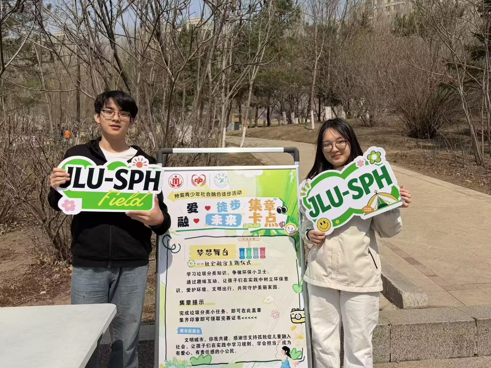 Volunteers displaying an illustrated learning board in the park