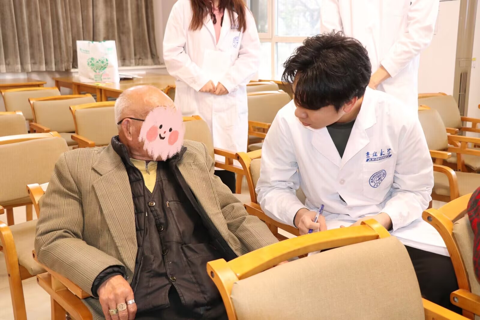 A volunteer using printed materials during a one-to-one conversation with an older adult