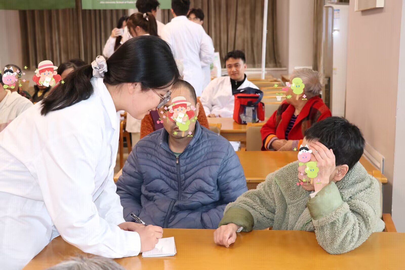 A volunteer supporting an older adult with a writing activity