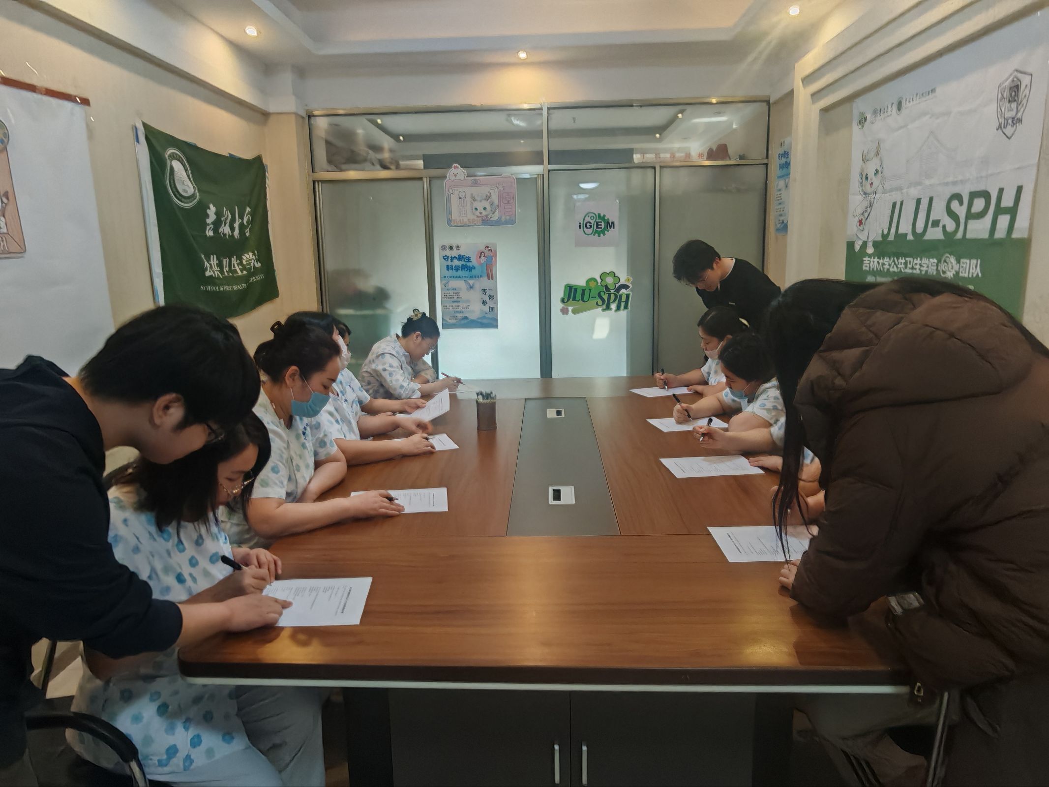 Participants completing written activities around a meeting table
