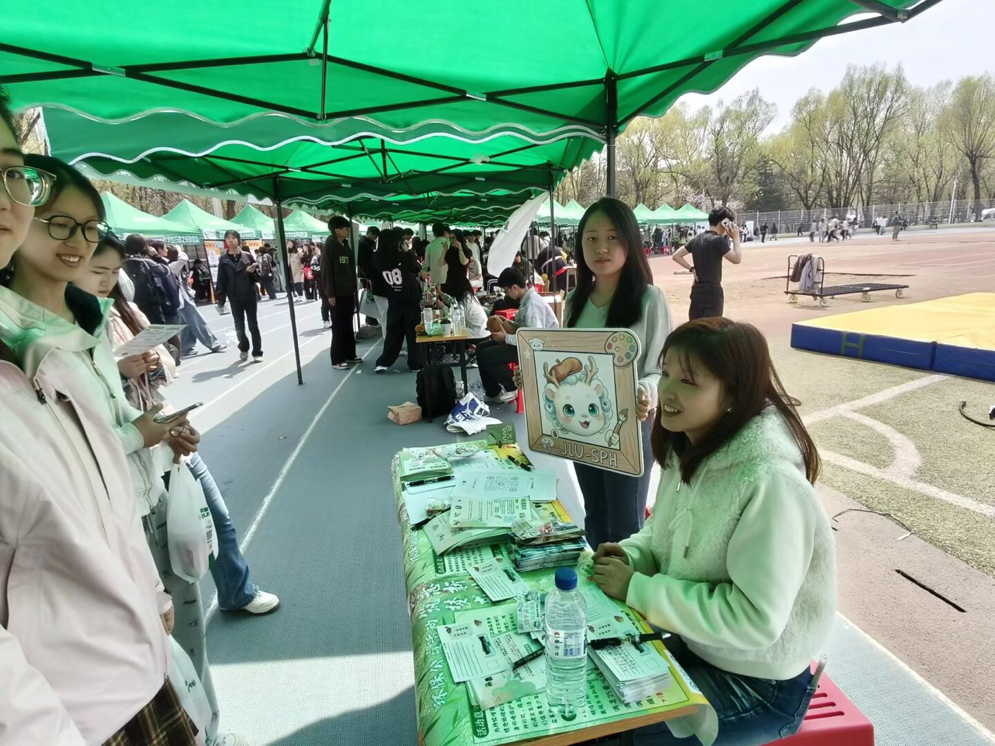 Visitors meeting volunteers at the science outreach table