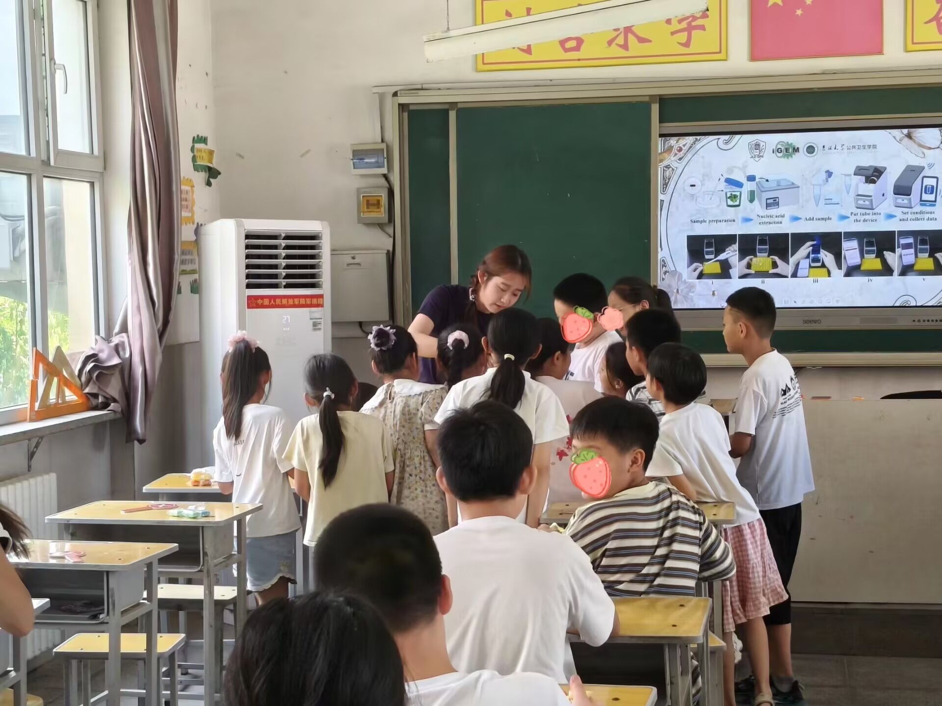 Children gathering around a hands-on classroom demonstration