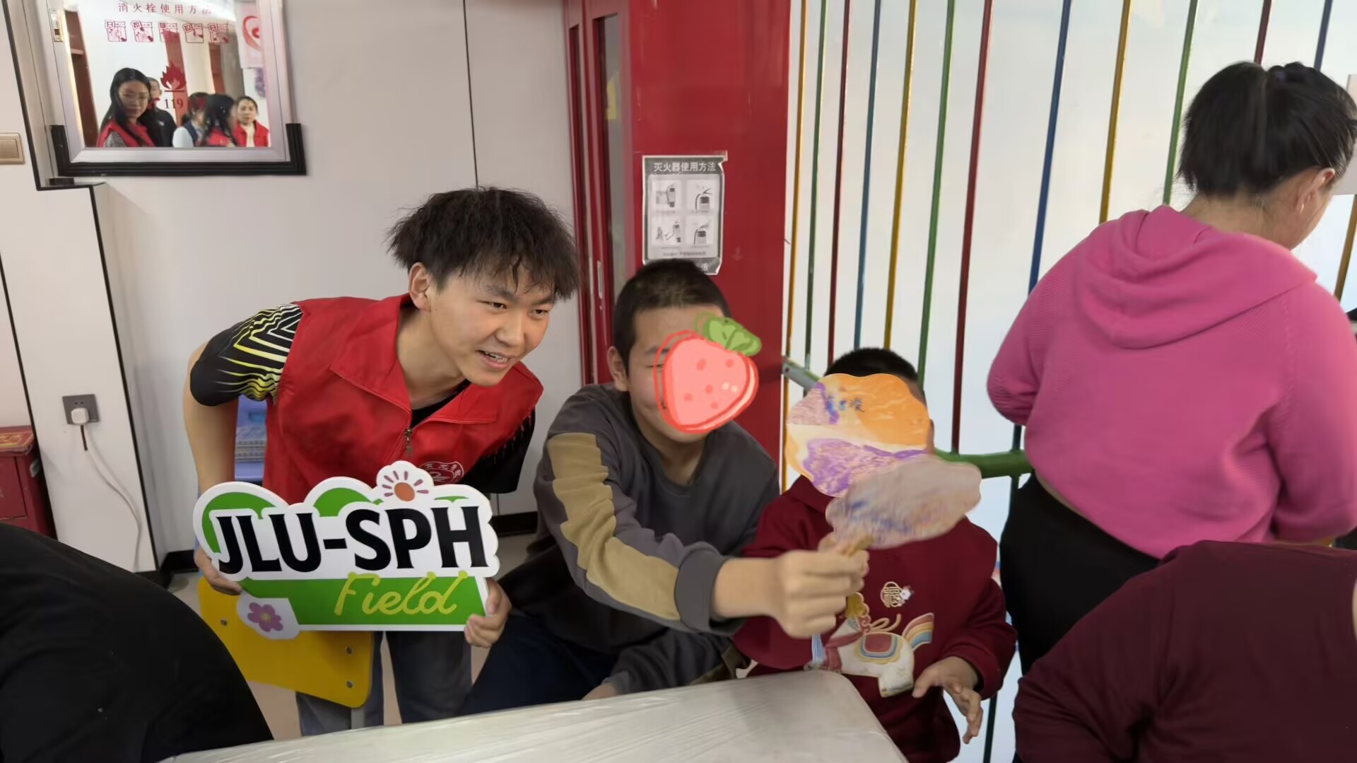 A volunteer and participant sharing a decorated fan