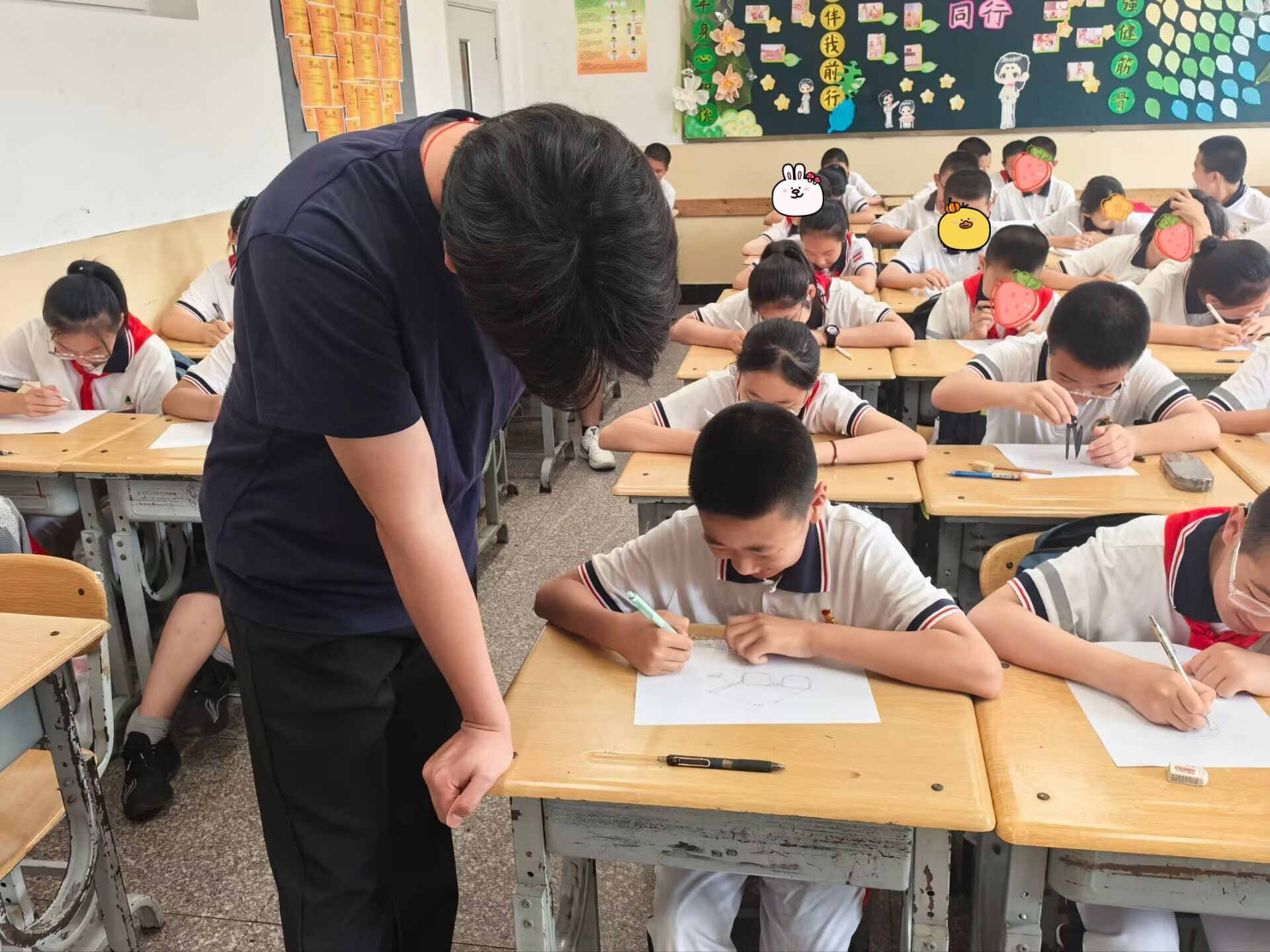 A volunteer guiding a student as they draw an invention idea